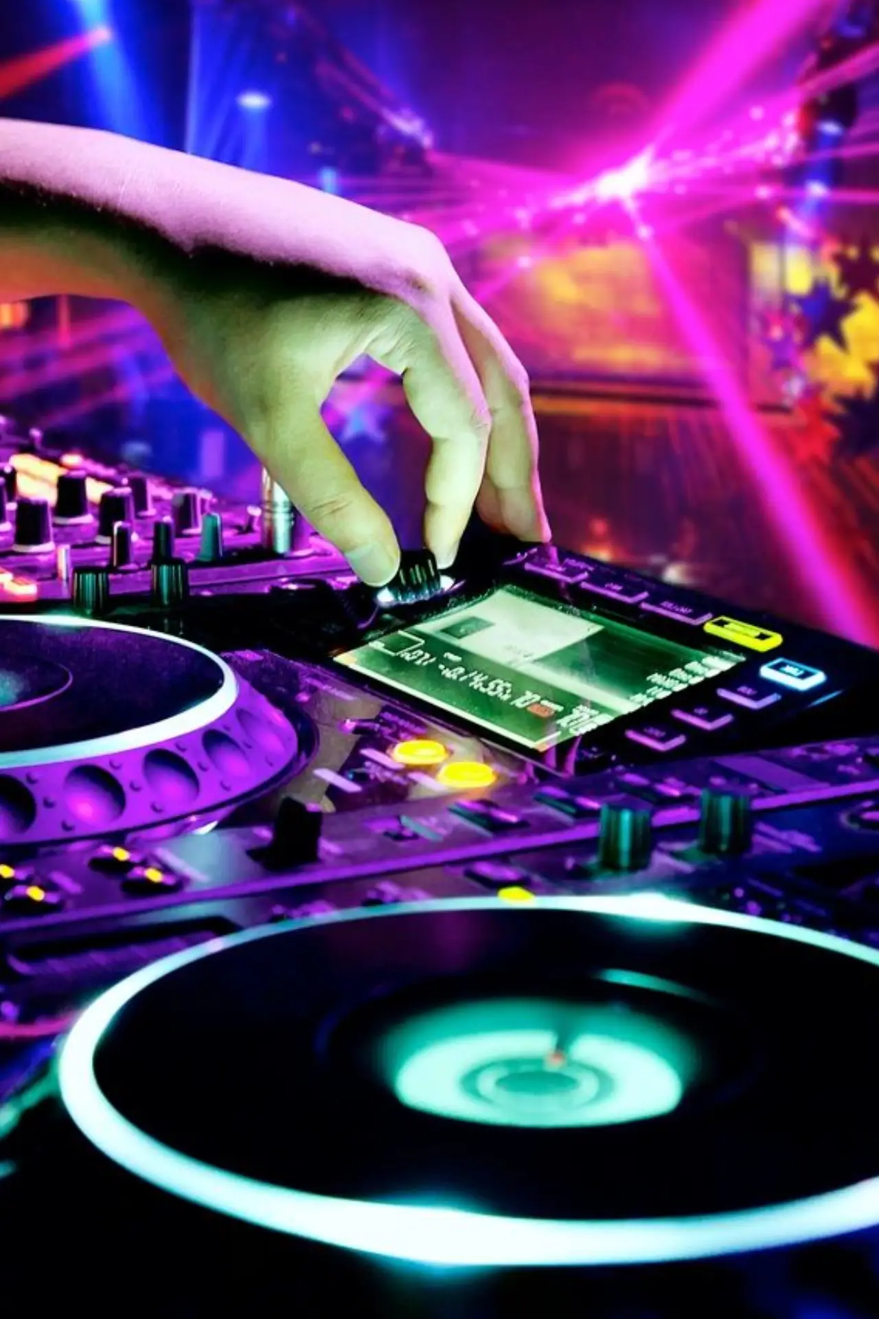 DJ adjusting mixer at vibrant nightclub.